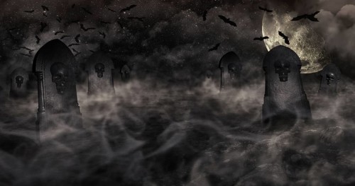 Cemetery At Night With Tombstones With Skulls And Cloudy Sky Full Of Stars in The Background.