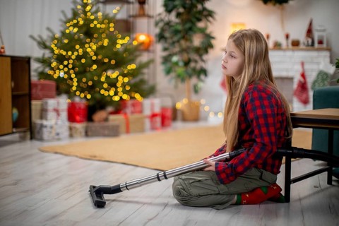 A thoughtful and reflective child who uses a crutch sits quietly beside a beautifully decorated