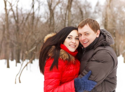 Happy young couple having fun in the winter park