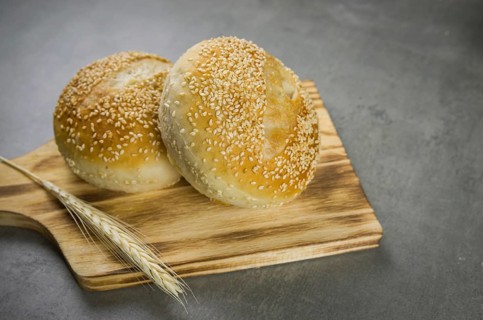 Beautiful Sourdough bread on gray background with dried wheat flower