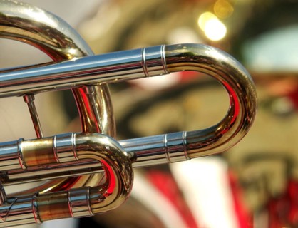 Abstract backgrounds of brass band instruments with details of a trombone in the foreground