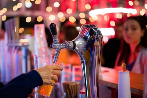 Pouring draft beer into a mug in a pub