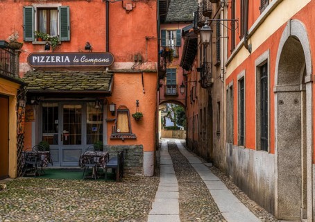 Orta San Giulio, Italy, 13 March, 2023: colorful shabby buildings in the old town center of Orta