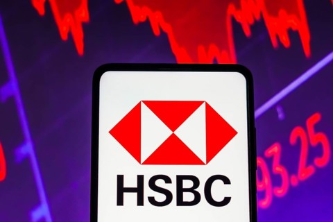 In this photo illustration the HSBC logo seen displayed on a smartphone screen, with graphic