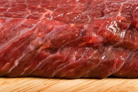 Raw beef steak meat on kitchen board close up