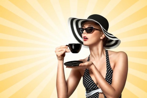 A creative vintage photo of a beautiful pin up girl drinking tea and showing good table manners on