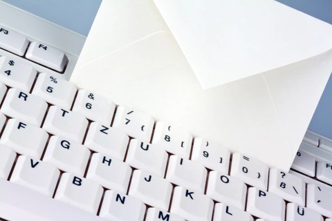 The keyboard of a computer and an envelope. Communication via e-mail, The keyboard of a computer