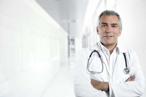 Gray hair expertise handsome senior doctor hospital portrait white corridor