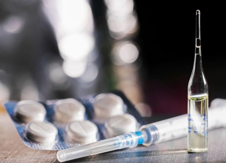 Pills, Syringe And Ampoule With Vaccination On Dark Table