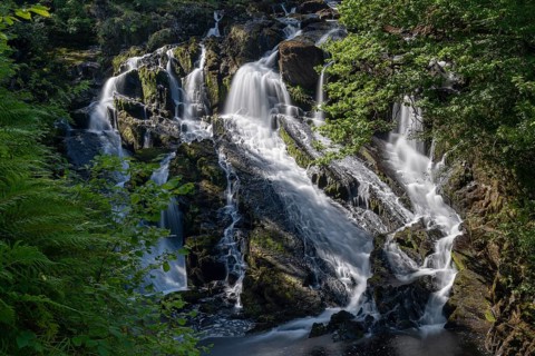 A view of the Swallow Falls waterfall in Anglesey in northern Wales in autumn splendor