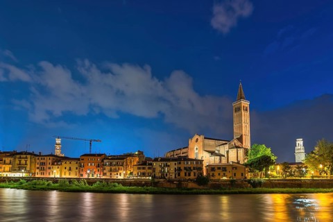 Verona Italy, night city skyline at Adige river and Basilica di Santa Anastasia