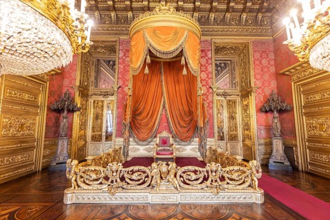 Turin, Italy, Circa August 2021: old throne room interior with chair in luxury palace. Red and gold