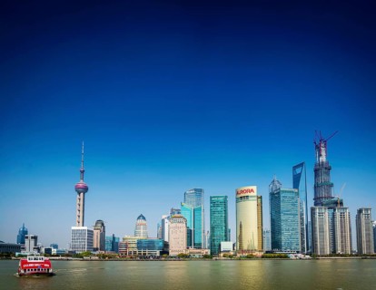Shanghai pudong city skyline and local river ferry boat in china