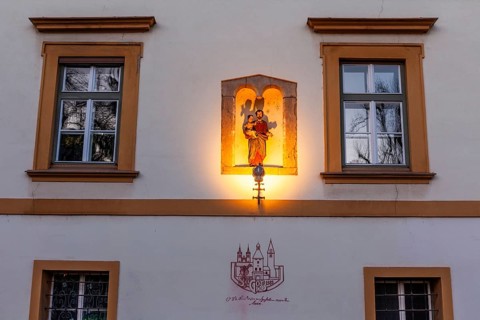 Sculptural group in a niche, saint holding the infant Jesus, depiction of the dissolution decree of