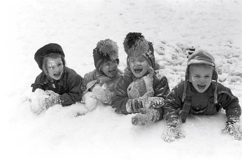 Winter in the 1950s. Children are playing in a park in Stockholm. They don't seem to be freezing.
