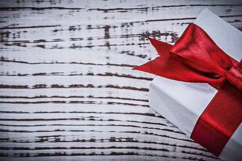 Present box on vintage wooden board holidays concept