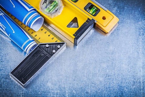 Blue engineering drawings construction levels square ruler on metallic background