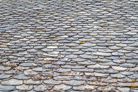 Detail of a roof covered with flat slabs of black slate on a house in Nonza, west coast of Cap