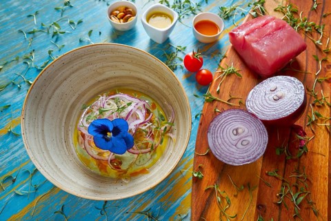 Fish ceviche latin preuvian recipe on bowl with pansy flower