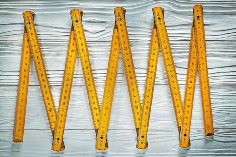 Yellow wooden meter on white board