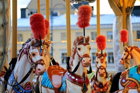 Colouful carousel horses on a traditional merry-go-round on Helsinki Christmas Market, Helsinki,