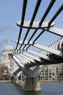 Pedestrians crossing Millennium Bridge over the River Thames, St. Paul's Cathedral, London,
