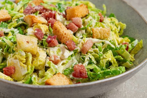 Brussels sprouts Caesar salad, with bacon and croutons, healthy food, homemade, no people