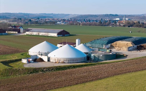 Green fields and a biogas plant in a quiet rural setting with a village, near Backnang,