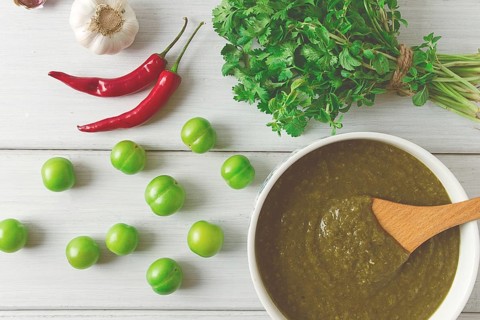 Tkemali sauce, traditional Georgian cuisine, green cherry plum, with ingredients for sauce,