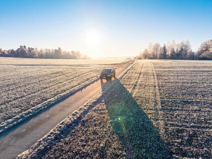 An SUV drives along a frosty country road in the winter morning light, Car Sharing, Electric car,