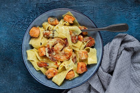 Papardelle pasta in creamy sauce with seafood, homemade, no people