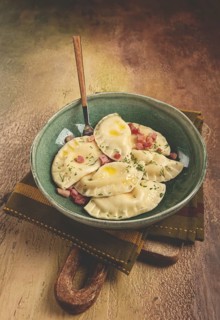 Dumplings, with fried prosciutto, a traditional dish of Polish cuisine, dumplings, top view,