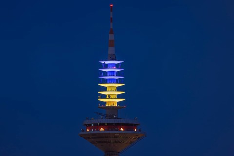 The Europe Tower in Frankfurt am Main shines in the Ukrainian national colours yellow and blue on