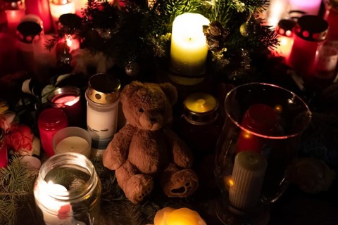 Commemoration of attack, small teddy bear and candles commemorate 20 December 2024, a man