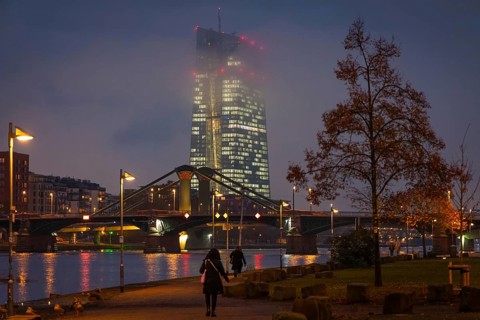Low clouds envelop the illuminated European Central Bank (ECB) in Frankfurt am Main in the evening.