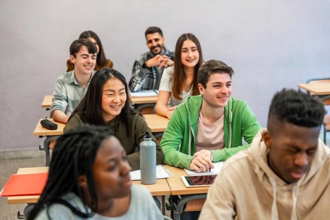 Multi ethnic university students attending a lesson and smiling, concept of education and