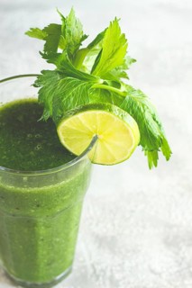 Glass with green smoothie, celery and spinach, apple and kiwi, cucumber, vegetable smoothie,
