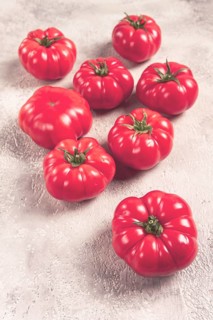Pink tomatoes scattered on the table, top view, close-up, no people