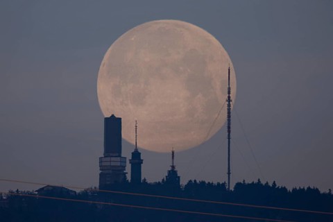 The first full moon of the year, also known as the wolf moon, disappears behind the Großer Feldberg