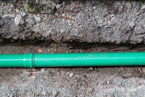 Newly laid green sewage pipe in a trench, Stuttgart, Baden-Württemberg