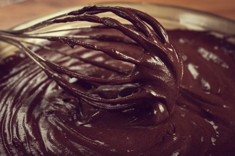 A bowl of chocolate dough, a whisk for whipping, baking, structure and consistency, homemade, top