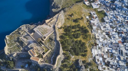 Drone shot, Acropolis of Lindos, late afternoon light, aerial view of an ancient fortress on the