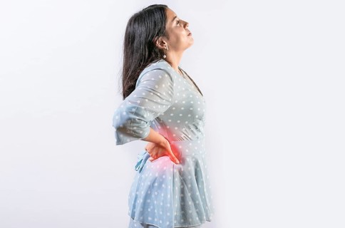 Suffering girl with back pain isolated. Young woman with spine problems isolated. Person with back
