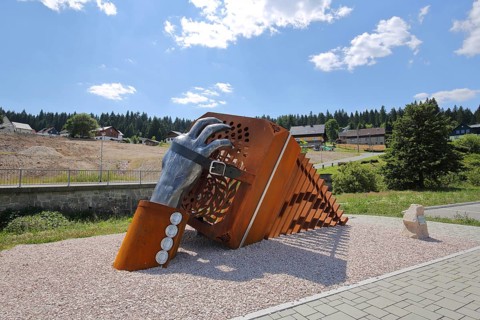 Sculpture bandoneon with hand, strap and buckle as a monument and symbol of musical instrument