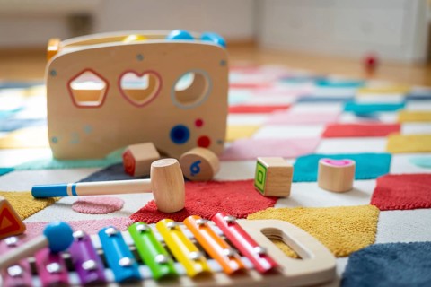 Young child toy concept: Close up of stylish wooden toddler toy in nursery