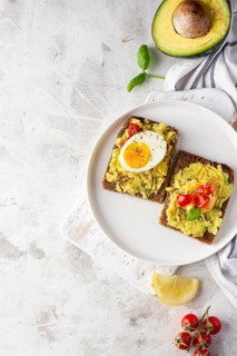 Delicious toast with veggie cream half avocado