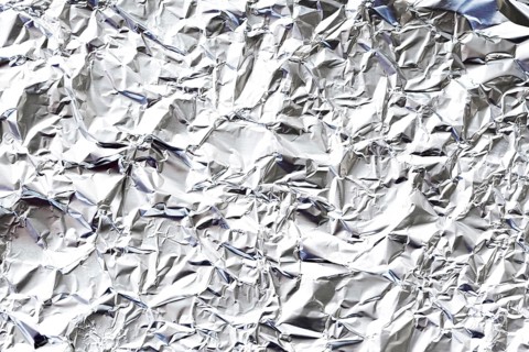 Crumpled white aluminium foil background
