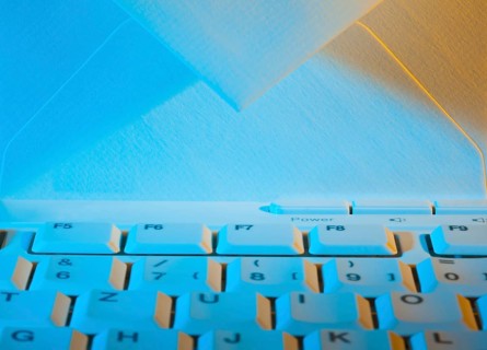 The keyboard of a computer and an envelope. Communication via e-mail, The keyboard of a computer