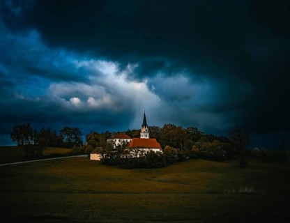 Dark storm clouds over a church