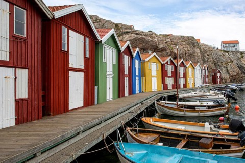 Small colourful houses by the sea. Typical houses in Sweden for the coastal landscape. Crab fishing
